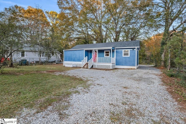 view of front of house with covered porch and a front lawn