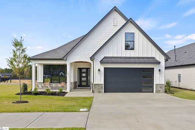 modern inspired farmhouse featuring a front lawn, a porch, and a garage