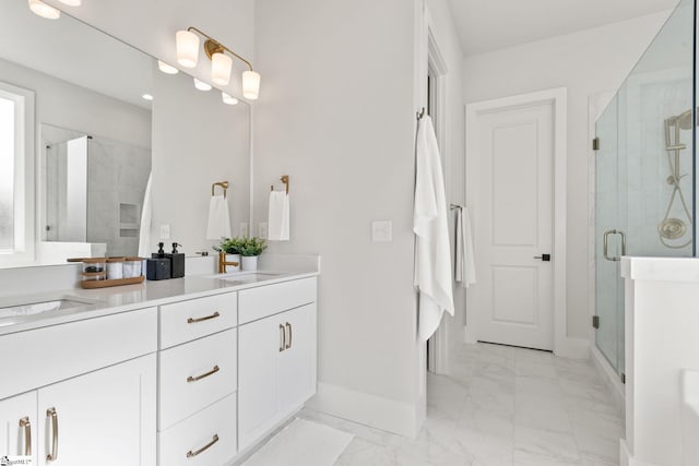 bathroom with vanity and a shower with shower door