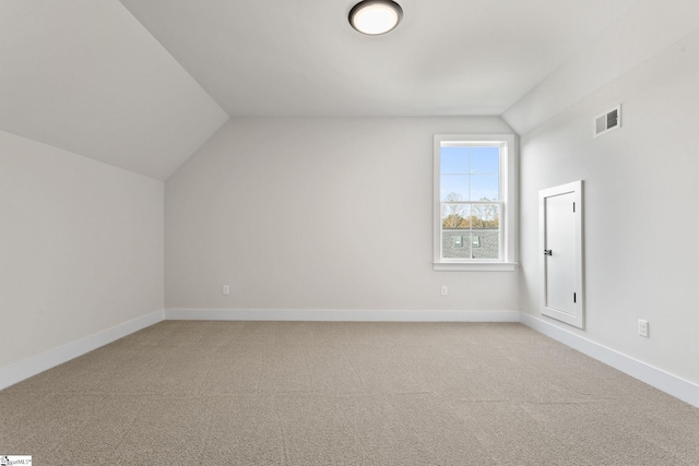 additional living space with carpet and vaulted ceiling