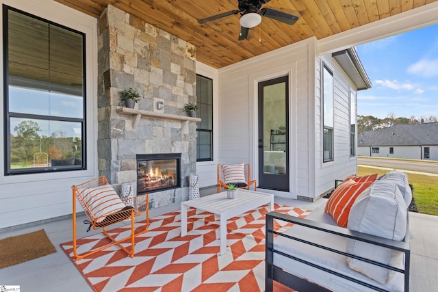 view of patio / terrace with an outdoor stone fireplace and ceiling fan