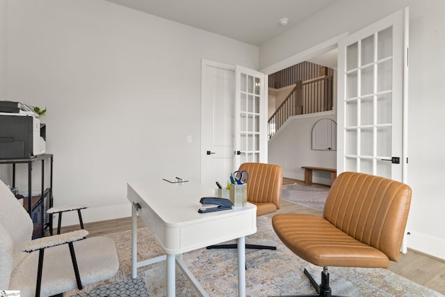 home office featuring french doors and light wood-type flooring