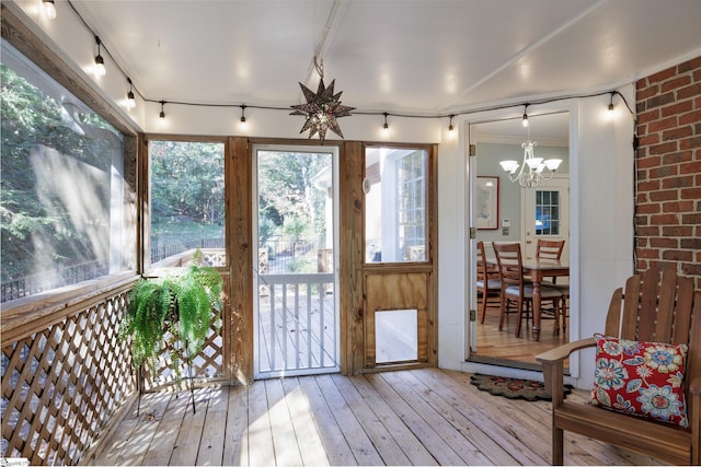 sunroom / solarium with a notable chandelier