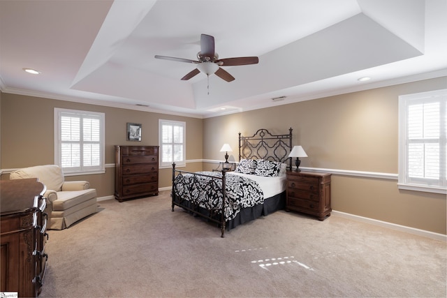 bedroom with light colored carpet, a raised ceiling, ceiling fan, and crown molding