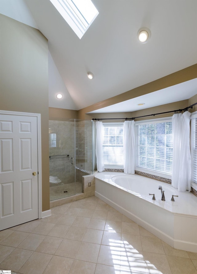 bathroom with shower with separate bathtub, high vaulted ceiling, a skylight, and tile patterned floors