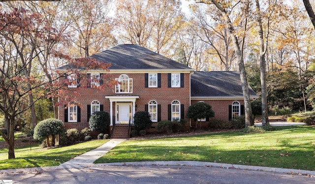 colonial-style house with a front yard