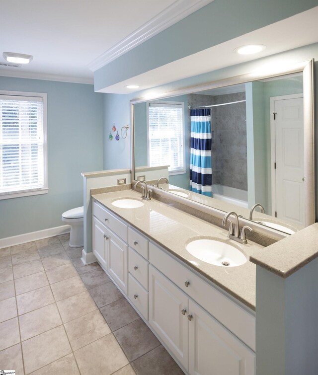 bathroom with toilet, tile patterned floors, plenty of natural light, and crown molding