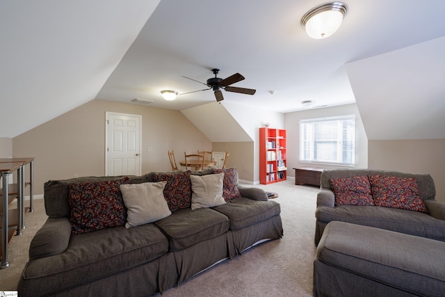 carpeted living room with ceiling fan and vaulted ceiling