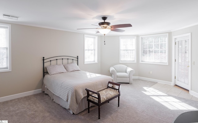 carpeted bedroom featuring ceiling fan and crown molding