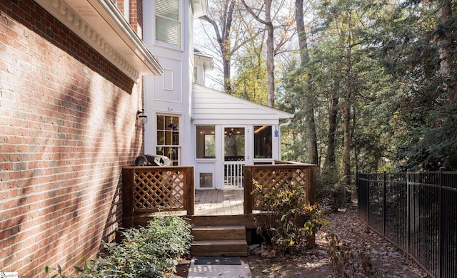 wooden terrace featuring a sunroom