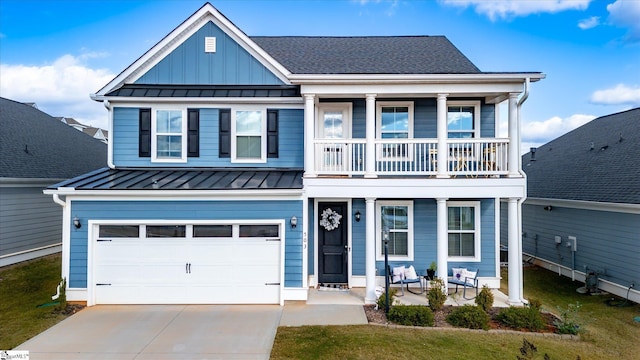 view of front of home with a balcony and a garage