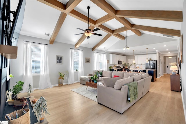 living room with ceiling fan, lofted ceiling with beams, and light wood-type flooring