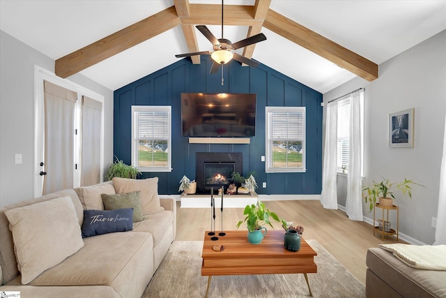 living room featuring light wood-type flooring, lofted ceiling with beams, and ceiling fan