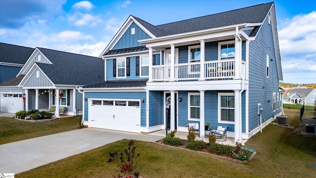 view of front of property with cooling unit, a balcony, a front lawn, and a garage