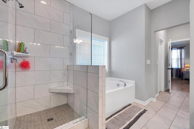 bathroom featuring shower with separate bathtub