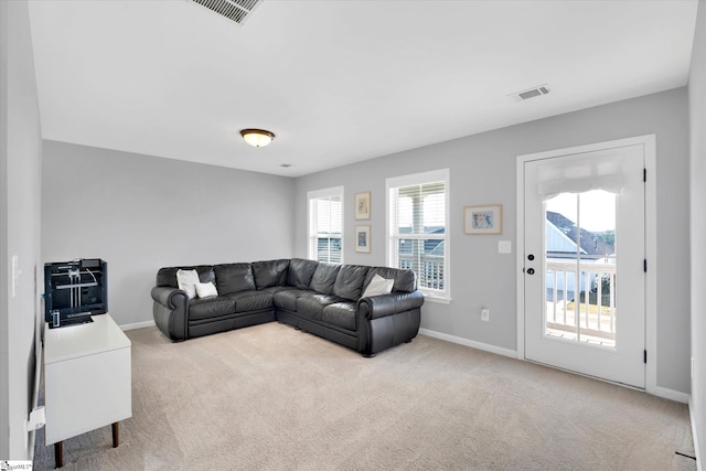 living room featuring carpet flooring and a wealth of natural light