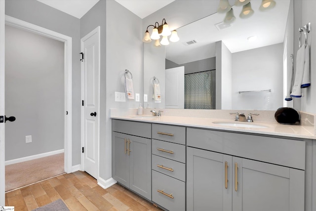 bathroom with vanity, wood-type flooring, and walk in shower