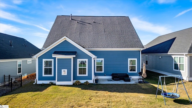 rear view of house with a lawn and a patio area