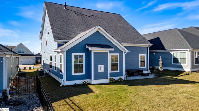 rear view of property featuring a yard and cooling unit