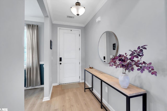 entryway featuring light wood-type flooring and crown molding