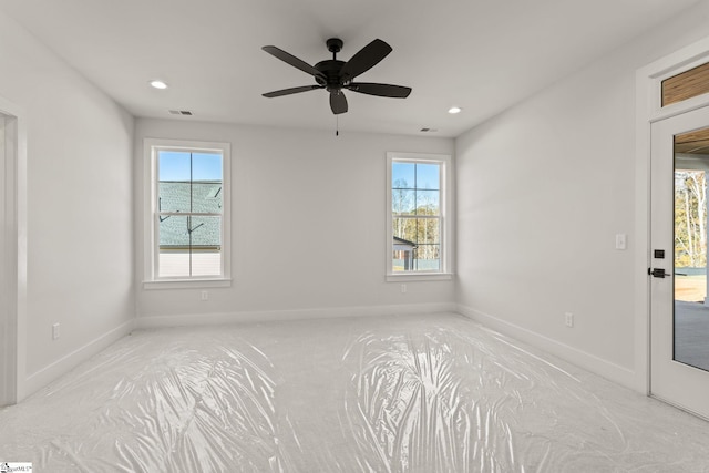 spare room with ceiling fan and a healthy amount of sunlight