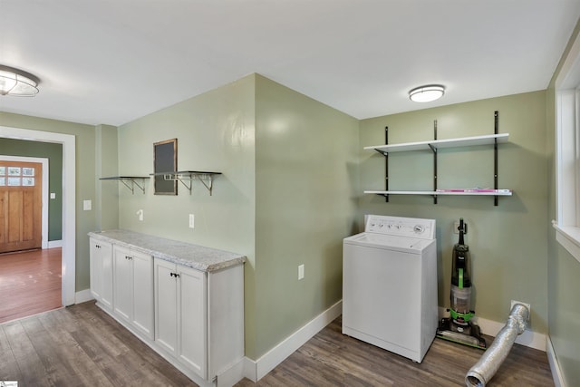 laundry area with hardwood / wood-style floors, washer / dryer, and cabinets