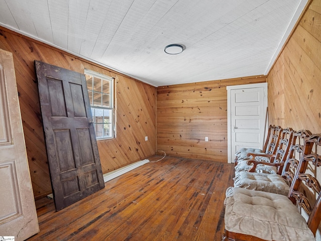 sitting room with lofted ceiling, wood walls, and wood-type flooring