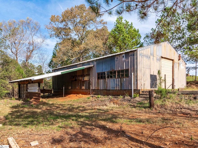 back of property featuring an outbuilding and a garage