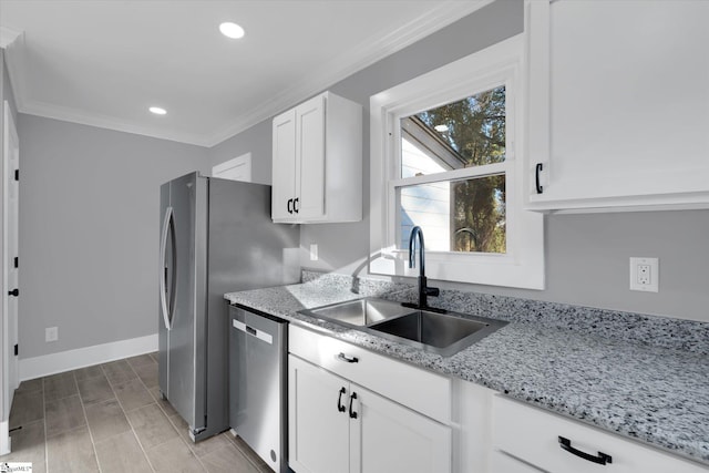 kitchen featuring dishwasher, sink, light stone counters, white cabinets, and ornamental molding