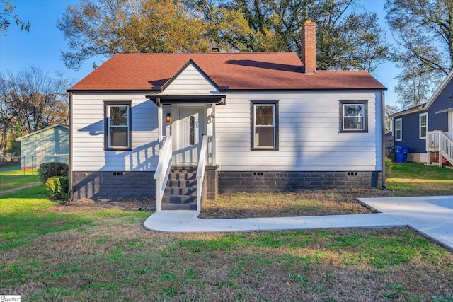 bungalow-style house with a front yard