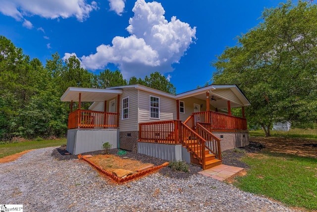 view of front of home featuring ceiling fan and a deck