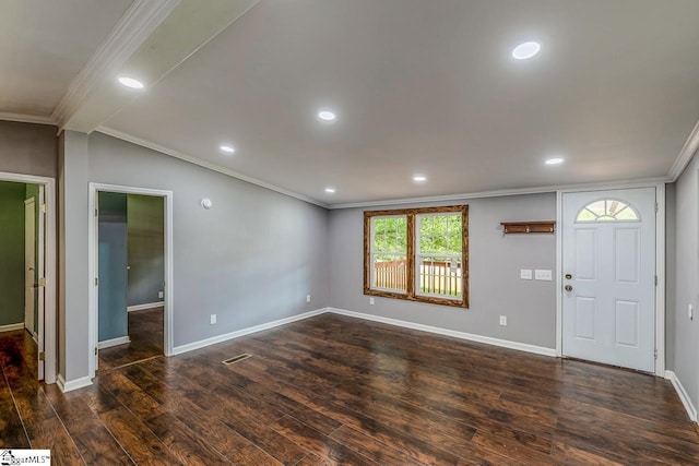 entryway featuring dark hardwood / wood-style flooring, ornamental molding, and vaulted ceiling