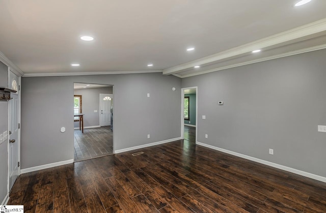 empty room featuring lofted ceiling, dark hardwood / wood-style flooring, and crown molding