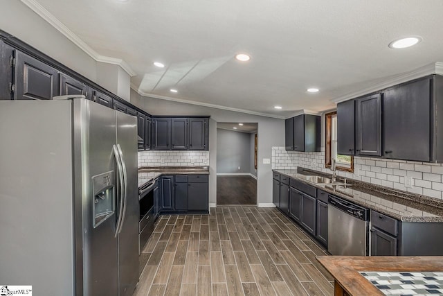 kitchen featuring lofted ceiling, dark wood-type flooring, sink, ornamental molding, and appliances with stainless steel finishes