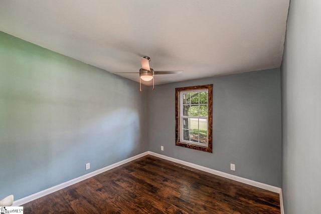 unfurnished room with ceiling fan and dark hardwood / wood-style flooring