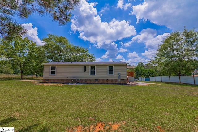 rear view of house featuring a yard