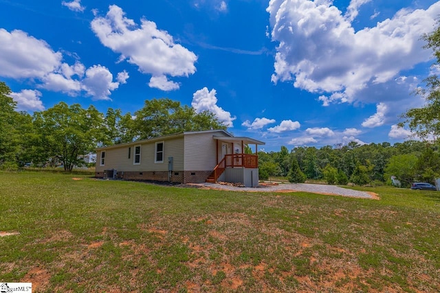 view of property exterior featuring a lawn and central AC