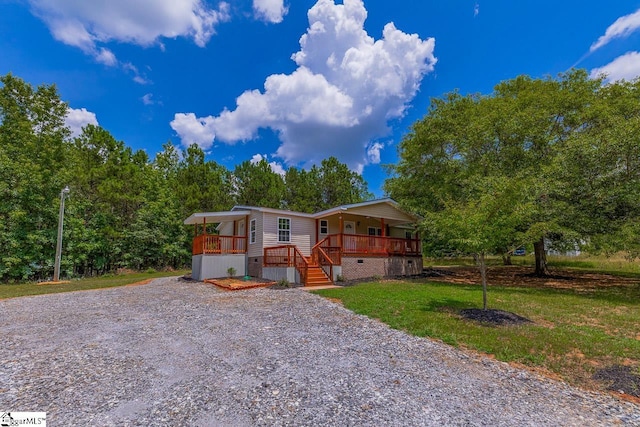 manufactured / mobile home with covered porch and a front lawn