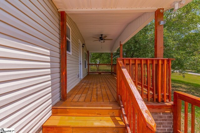 wooden deck with a porch and ceiling fan