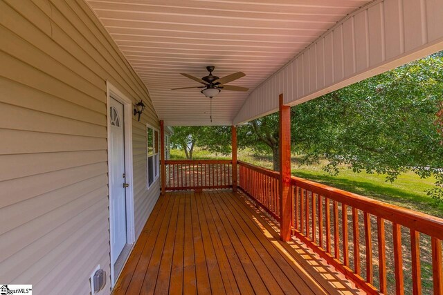 wooden terrace featuring ceiling fan