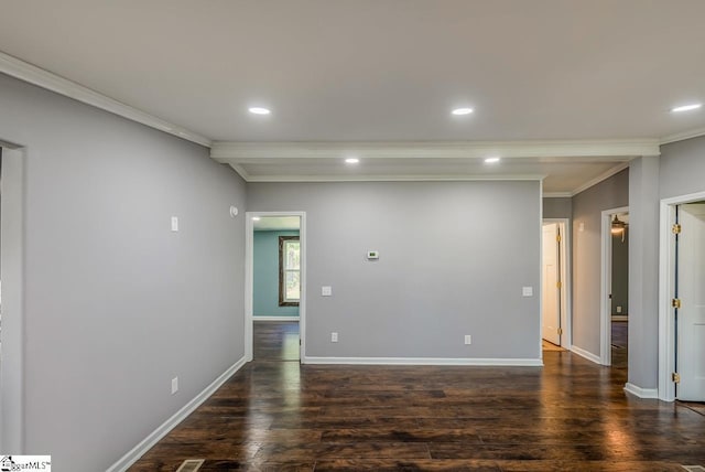 unfurnished room with ornamental molding and dark wood-type flooring