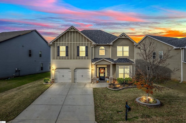 view of front of property featuring a garage and a yard