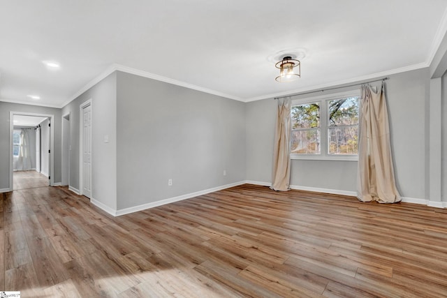 empty room featuring light hardwood / wood-style floors and ornamental molding