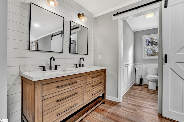 bathroom featuring crown molding, toilet, vanity, and hardwood / wood-style flooring