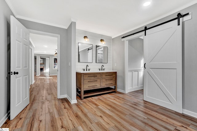 bathroom featuring hardwood / wood-style floors, vanity, and crown molding