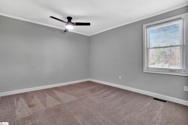 carpeted spare room featuring crown molding and ceiling fan