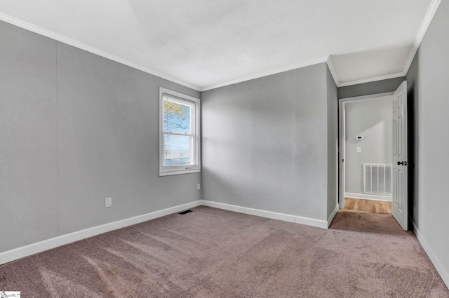 empty room featuring light colored carpet and crown molding