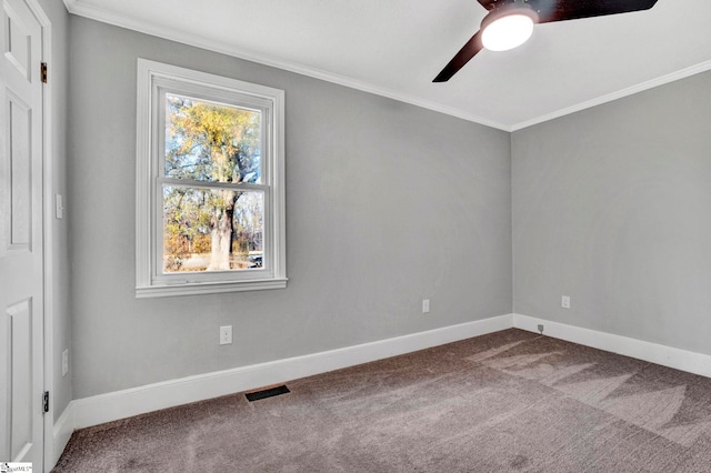 carpeted spare room featuring ceiling fan and crown molding