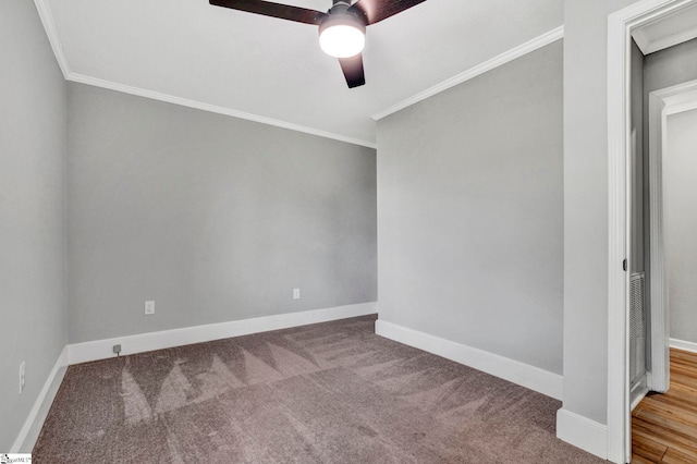 empty room featuring carpet flooring, crown molding, and ceiling fan