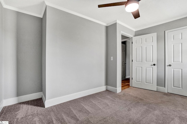 unfurnished bedroom with ceiling fan, carpet floors, and crown molding